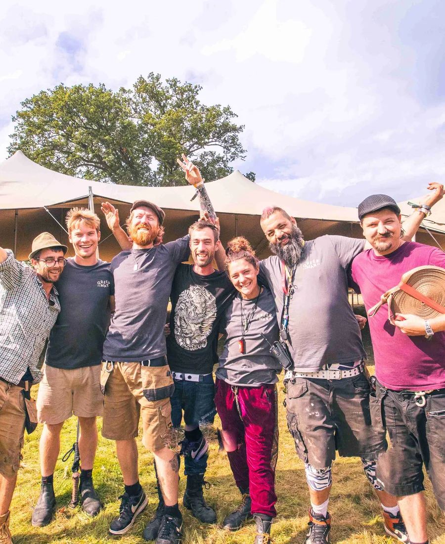 The crew together in front of the tent